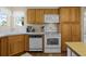 This kitchen features white appliances, wood cabinets, and a breakfast bar for casual dining at 815 Cortez Ave, Lady Lake, FL 32159