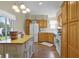 Bright kitchen featuring an island, wooden cabinets and a sliding door for plenty of natural light at 815 Cortez Ave, Lady Lake, FL 32159