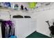 Laundry room with a washer, dryer, shelves, and accessories at 815 Cortez Ave, Lady Lake, FL 32159