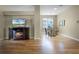Spacious living area featuring wood floors, an electric fireplace, and access to dining room at 815 Cortez Ave, Lady Lake, FL 32159