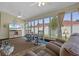 Bright sunroom with many windows, ceiling fan, and a cozy seating area at 815 Cortez Ave, Lady Lake, FL 32159
