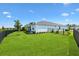 Lush backyard featuring green grass and a black metal fence at 8178 Penrose Pl, Wildwood, FL 34785