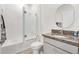 Bright bathroom featuring a shower-tub combo and vanity with granite countertop and modern fixtures at 8178 Penrose Pl, Wildwood, FL 34785