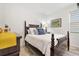 Well-lit bedroom with decorative pillows, wood-look floors, and neutral paint, creating a warm atmosphere at 8178 Penrose Pl, Wildwood, FL 34785