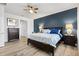 Main bedroom features a modern color scheme, a ceiling fan, and hardwood floors at 8178 Penrose Pl, Wildwood, FL 34785