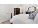 Cozy bedroom with wood-look flooring, dresser, and a large closet, offering comfortable living space at 8178 Penrose Pl, Wildwood, FL 34785