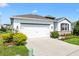 Charming single-story home with a two-car garage and well-manicured landscaping at 8178 Penrose Pl, Wildwood, FL 34785