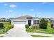 Inviting single-story home with a two-car garage, fresh landscaping, and a cozy entrance at 8178 Penrose Pl, Wildwood, FL 34785