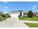 Well-maintained single-Gathering home with a tidy lawn and a convenient two-car garage at 8178 Penrose Pl, Wildwood, FL 34785