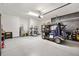 A spacious garage featuring a golf cart and additional bicycles at 8178 Penrose Pl, Wildwood, FL 34785