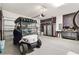 Spacious garage featuring a golf cart and ample storage cabinets at 8178 Penrose Pl, Wildwood, FL 34785