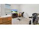Home gym with workout bench, dumbbells, and a TV, providing convenient fitness options at 8178 Penrose Pl, Wildwood, FL 34785
