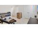 Home gym with workout equipment, dumbbell rack, and tile floors, perfect for staying in shape at 8178 Penrose Pl, Wildwood, FL 34785