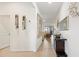 Bright hallway with tile flooring, elegant wall decor, and a glimpse into the living area at 8178 Penrose Pl, Wildwood, FL 34785