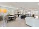 Open concept kitchen features a central island with seating, stainless appliances and a dining area at 8178 Penrose Pl, Wildwood, FL 34785