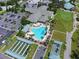 Beautiful aerial view of community center with large pool, shuffleboard courts, and clubhouse at 8779 Se 141St Lane Rd, Summerfield, FL 34491