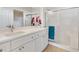 Bright bathroom with white vanity, quartz countertop, and glass-enclosed shower with a seat at 8779 Se 141St Lane Rd, Summerfield, FL 34491
