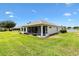 Beautiful home exterior featuring a screened lanai and well-maintained lawn on a sunny day at 8779 Se 141St Lane Rd, Summerfield, FL 34491