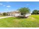 Charming home with a well-maintained lawn, landscaped garden, and mature tree, offering great curb appeal in a serene setting at 8779 Se 141St Lane Rd, Summerfield, FL 34491