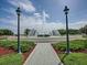 Beautiful fountain featuring lush landscaping, clear water, and ornate lampposts at 8779 Se 141St Lane Rd, Summerfield, FL 34491