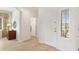 Bright foyer with neutral tones, showcasing the entrance door and a view into the adjacent rooms, highlighting the open layout at 8779 Se 141St Lane Rd, Summerfield, FL 34491