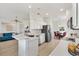 Bright kitchen features white cabinetry, stainless steel appliances, and an open layout to the living areas at 8779 Se 141St Lane Rd, Summerfield, FL 34491