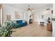 Spacious living room with light flooring, a cozy couch, and open access to other rooms, creating a welcoming and airy atmosphere at 8779 Se 141St Lane Rd, Summerfield, FL 34491