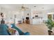 Bright living room with an open layout, modern decor, and seamless flow to the kitchen and dining area, perfect for entertaining at 8779 Se 141St Lane Rd, Summerfield, FL 34491