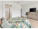 Spacious main bedroom with neutral paint, a ceiling fan, and an ensuite bathroom at 8779 Se 141St Lane Rd, Summerfield, FL 34491