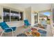 Outdoor screened patio with comfortable seating and view of lush backyard at 8779 Se 141St Lane Rd, Summerfield, FL 34491