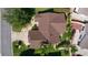 A home with a brown roof surrounded by lush landscaping and neighboring houses at 898 Abaco Path, The Villages, FL 32163