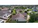 A home with a brown roof surrounded by lush landscaping and neighboring houses at 898 Abaco Path, The Villages, FL 32163