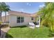 Well-maintained backyard featuring mature landscaping, irrigation, vinyl siding, and covered lanai at 898 Abaco Path, The Villages, FL 32163