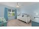 Serene bedroom with ample natural light, ceiling fan, and stylish furnishings at 898 Abaco Path, The Villages, FL 32163