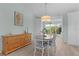 Coastal dining area with a light wood table, white chairs, and beachy decor at 898 Abaco Path, The Villages, FL 32163