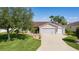 Charming single-story home featuring a well-manicured lawn and inviting curb appeal on a sunny day at 898 Abaco Path, The Villages, FL 32163
