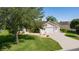 Beautiful home with an attached garage, attractive landscaping and an American flag on display at 898 Abaco Path, The Villages, FL 32163