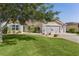 Charming single-story home with well-manicured lawn, mature tree, tasteful landscaping, and inviting curb appeal at 898 Abaco Path, The Villages, FL 32163