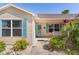 Welcoming front porch with colorful plants, accent shutters, and inviting curb appeal at 898 Abaco Path, The Villages, FL 32163