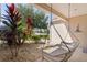 Cozy front porch swing with shaded landscaping and view of the neighborhood at 898 Abaco Path, The Villages, FL 32163