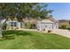 Charming single-story home with a well-manicured lawn, mature tree, and two-car garage at 898 Abaco Path, The Villages, FL 32163