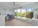 Bright office featuring large window with lush landscaping and natural light, desk, ceiling fan, and wood flooring at 898 Abaco Path, The Villages, FL 32163