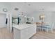 Open floor plan kitchen with island, stainless appliances, and connecting living space at 898 Abaco Path, The Villages, FL 32163