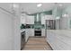 Spacious kitchen with stainless steel appliances, white cabinets, and modern lighting at 898 Abaco Path, The Villages, FL 32163