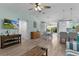 Inviting living room with TV, stylish furnishings, and an open layout leading to the kitchen and dining area at 898 Abaco Path, The Villages, FL 32163