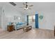 Cozy living room with a comfortable couch, bright window, ceiling fan, and fresh natural lighting at 898 Abaco Path, The Villages, FL 32163