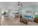 Open-concept living room with modern furnishings, ceiling fan, and seamless flow to the kitchen at 898 Abaco Path, The Villages, FL 32163