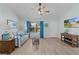 Bright living room with a comfortable couch, ceiling fan, TV and natural light streaming through the windows at 898 Abaco Path, The Villages, FL 32163