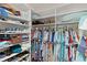 Spacious walk-in closet featuring custom shelving for shoes, baskets, and folded clothing at 898 Abaco Path, The Villages, FL 32163