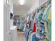 Well-organized walk-in closet with custom shelving and plenty of hanging space for clothes and accessories at 898 Abaco Path, The Villages, FL 32163